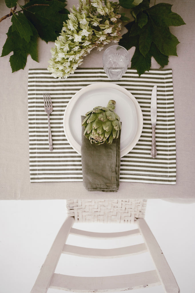 olive linen napkin paired with striped placemat