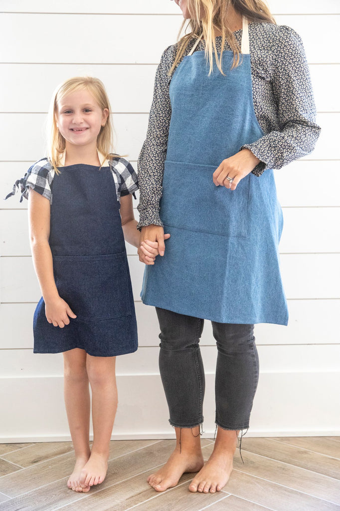 mom and daughter wearing matching denim aprons